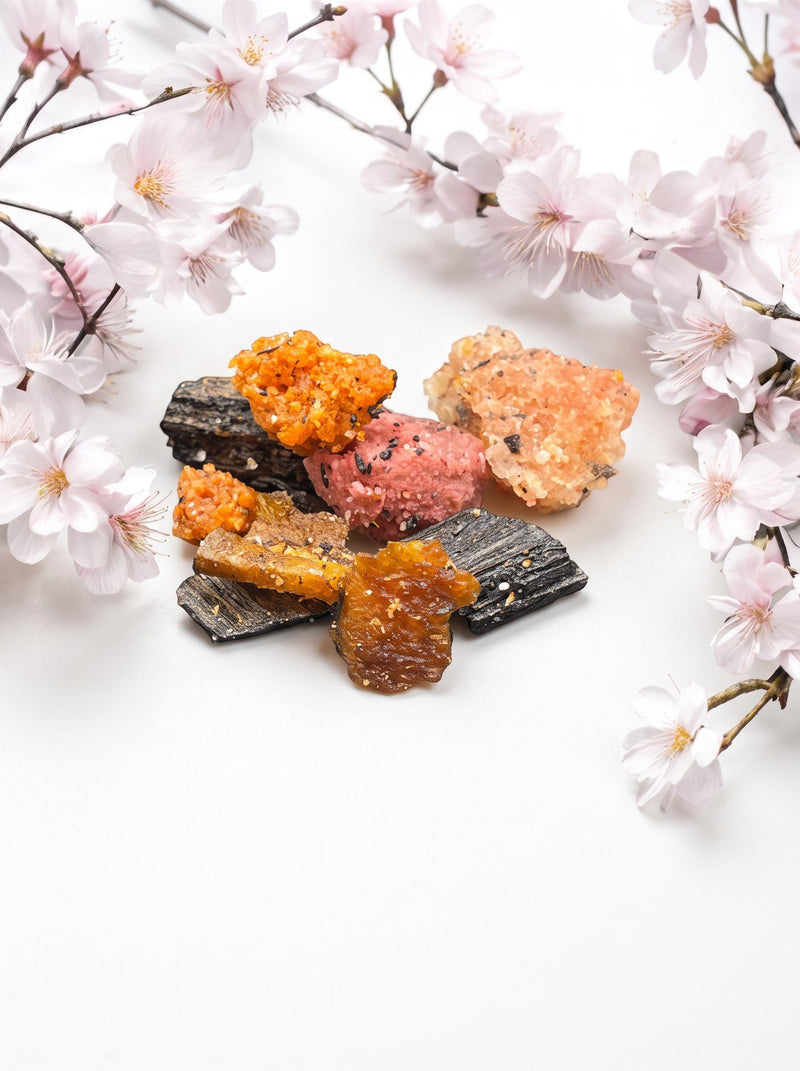 Floral bakhoor pieces with oud chips among cherry blossoms